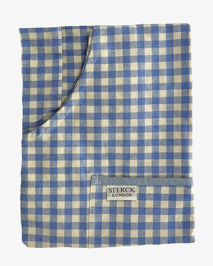 gingham apron for children with large front pocket and adjustable neck strap. Sterck & Co. Folded.