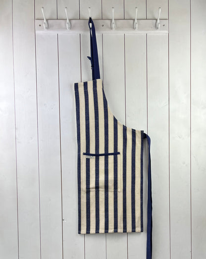 A classic wide striped cotton apron with double front pockets and adjustable neck tie. From Sterck & Co.