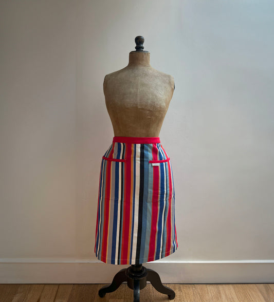 A modern and stylish multi-coloured stripy half apron from Sterck &amp; Co. Made from high quality and durable cotton, this apron is machine washable. 