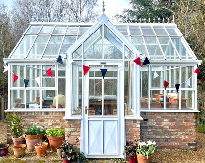 Union Jack, red, white and blue bunting on a green house in spring. From Sterck and Co.