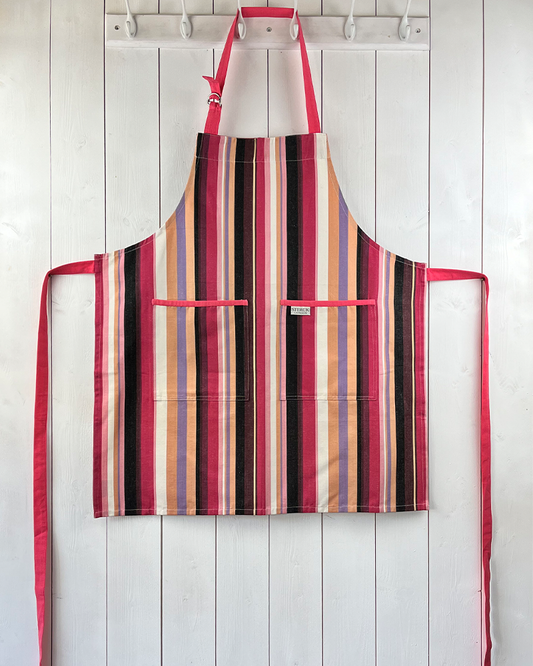 A modern and stylish pink stripy cotton apron with double front pockets and adjustable neck strap.
