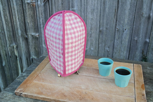 Keep your pot of coffee warm with this classic pink gingham cafetiere / French press cover from Sterck & Co.
