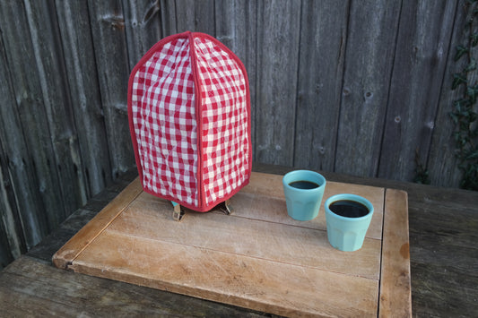Keep your pot of coffee warm with this classic red gingham cafetiere / French press cover from Sterck & Co.