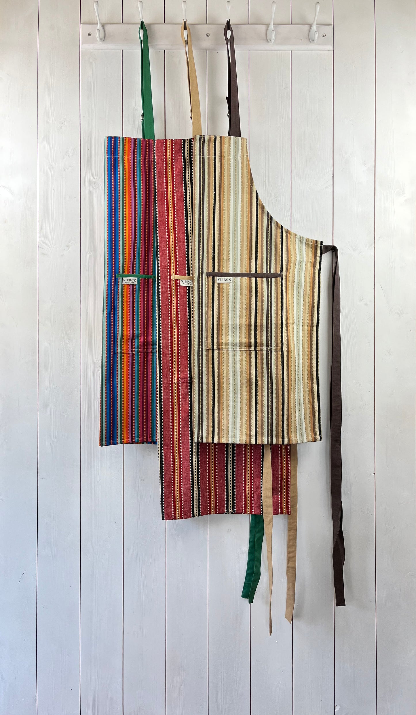 a selection of three stripy aprons from sterck & co's 100% cotton altiplano range.