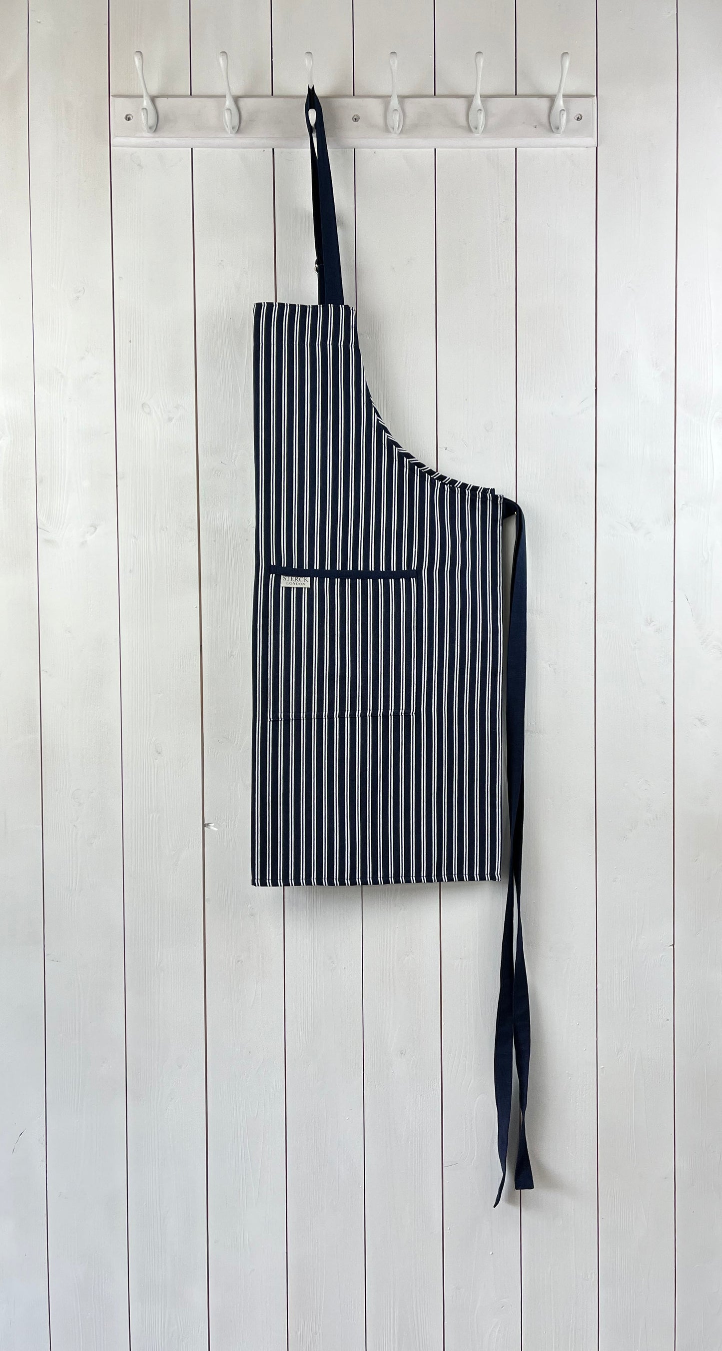 classic blue and white striped cotton 'butcher's apron' with double front pockets and adjustable neck strap. sterck & co.