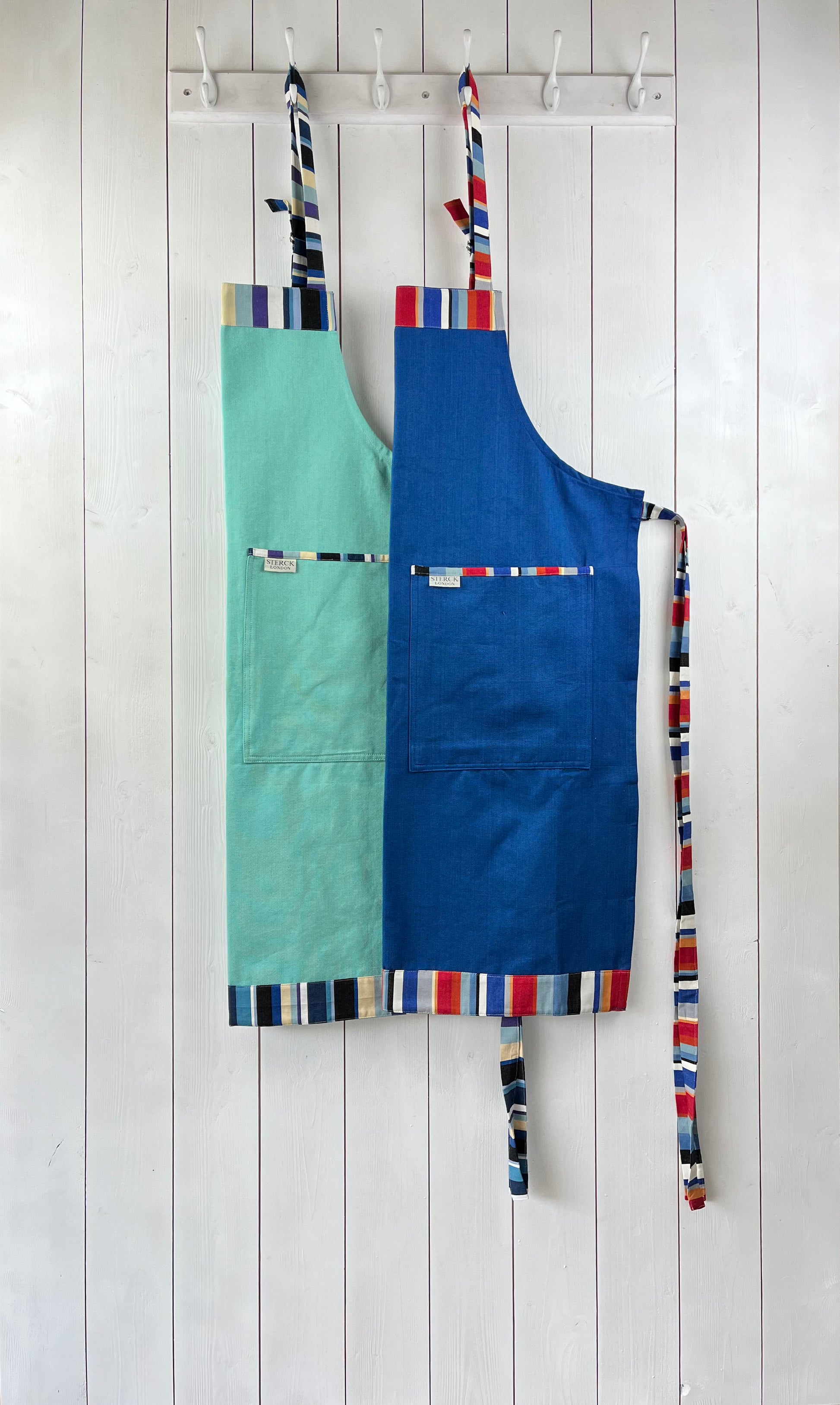 Caloosa mint and Waikiki royal blue cotton aprons.