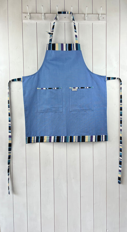 A bold blue cotton apron with stripy detailing. Double front pockets, stripy ties and adjustable neck strap. Sterck & Co. Caloosa Sky.