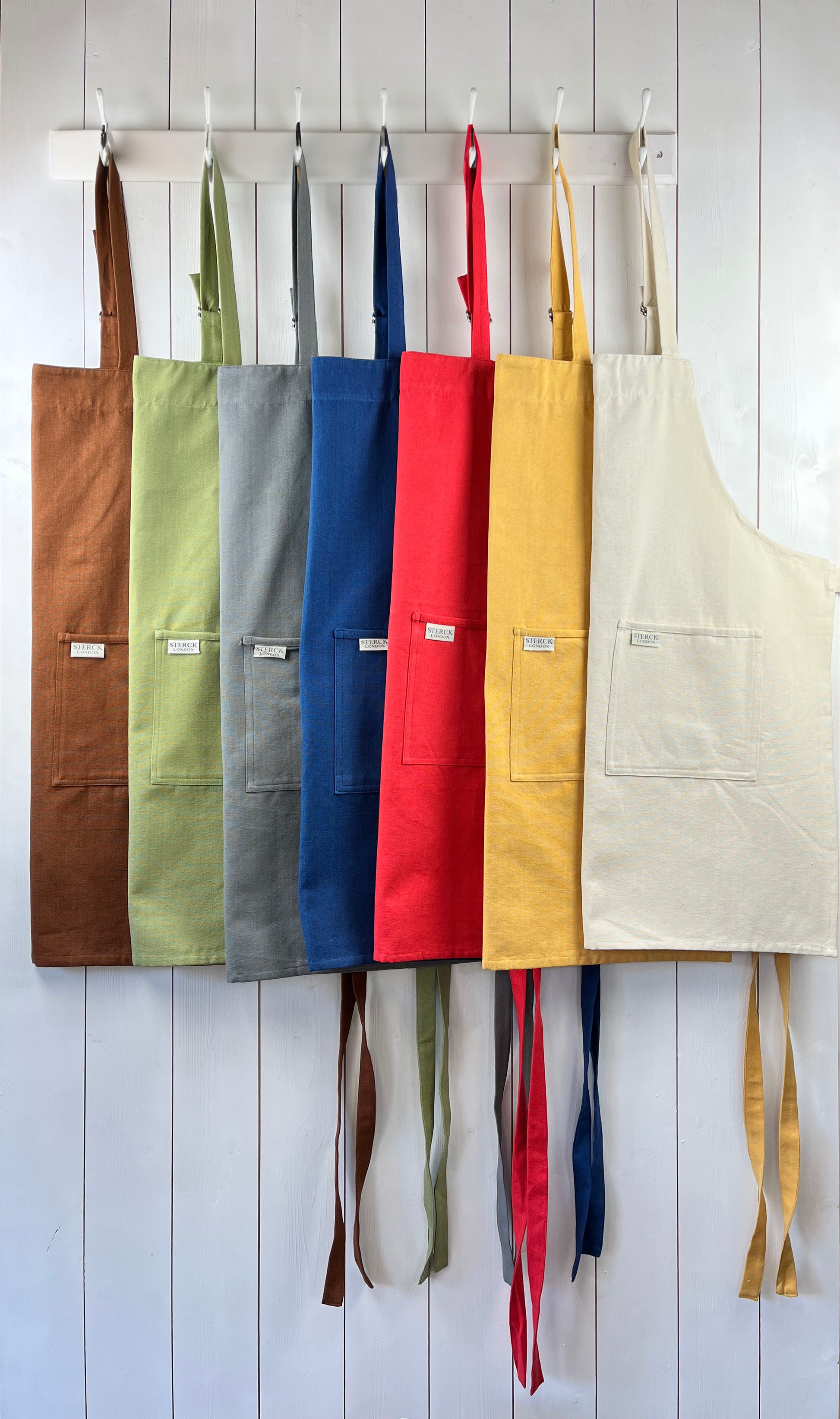 Carom collection. Boldly coloured cotton aprons from Sterck & Co.