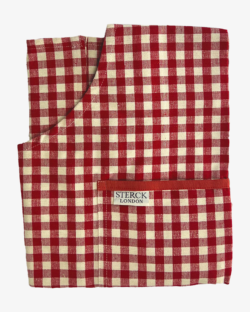 folded red gingham apron for child showing pocket detailing