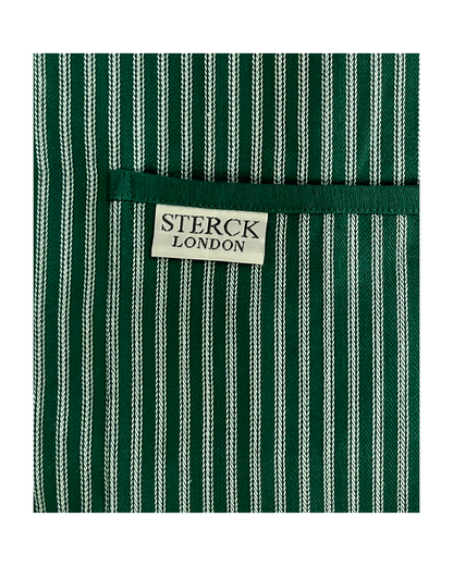 Green striped cotton apron with double front pockets, green ties and adjustable neck strap. Sterck & Co. Drum green. Close up fabric and pocket detail.