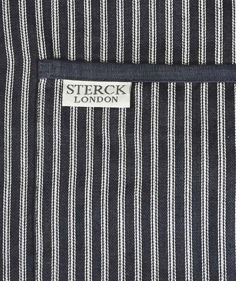 Grey striped cotton apron with double front pockets, grey ties and adjustable neck strap. Sterck & Co. Drum grey.