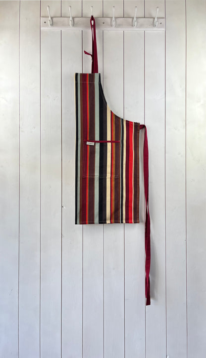 A modern striped cotton apron with double front pockets and adjustable neck strap. Sterck & Co.