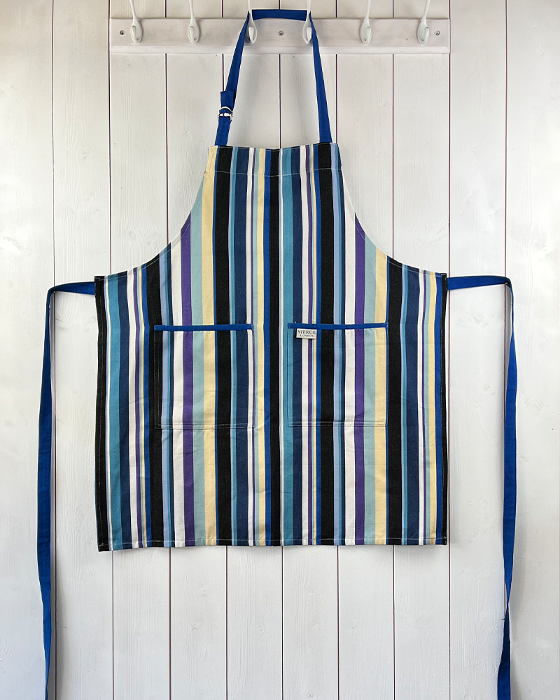 a modern and stylish blue stripy apron with double front pockets, blue ties and adjustable neck strap. 100% cotton. sterck & co.