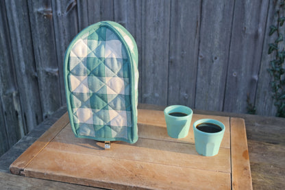 Green checked cafetiere french press cover for keeping coffee warm. From Sterck & Co.