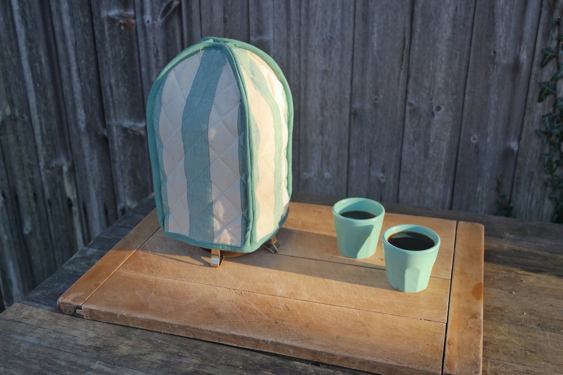 Green striped cafetiere french press cover for keeping coffee warm. From Sterck & Co.