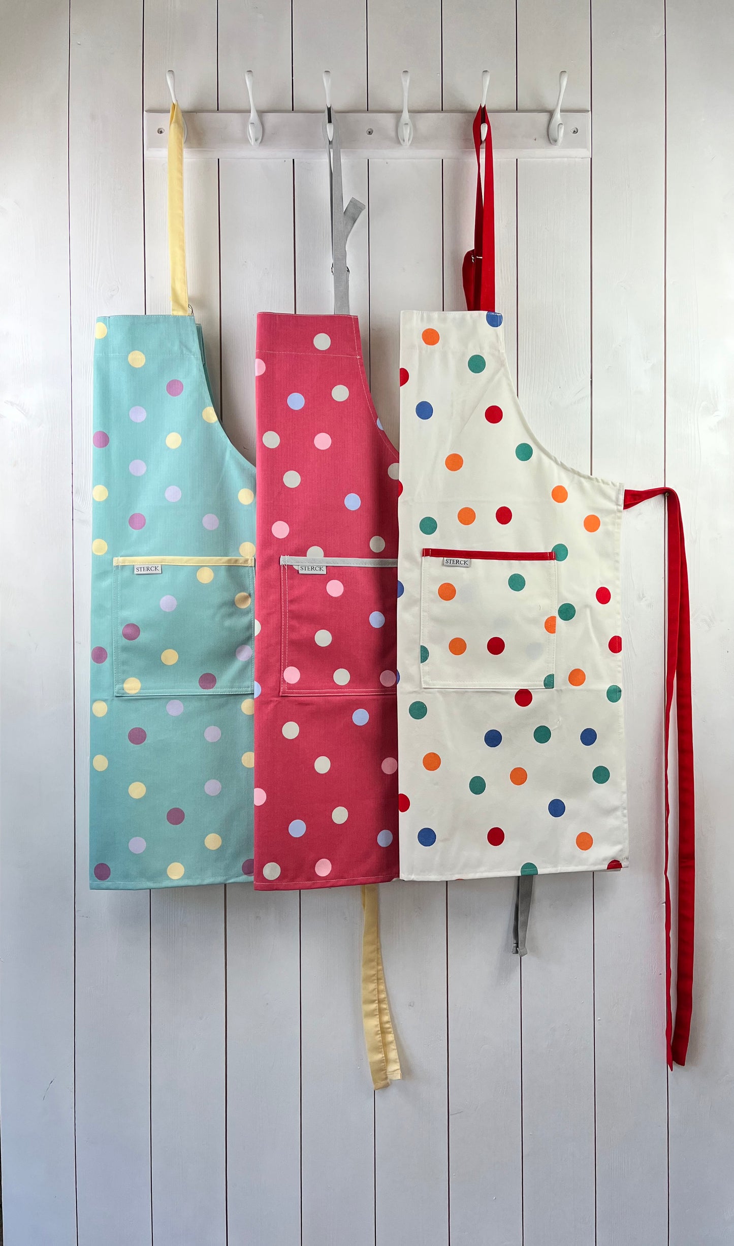 collection of spotty aprons from sterck & co, 100% cotton.