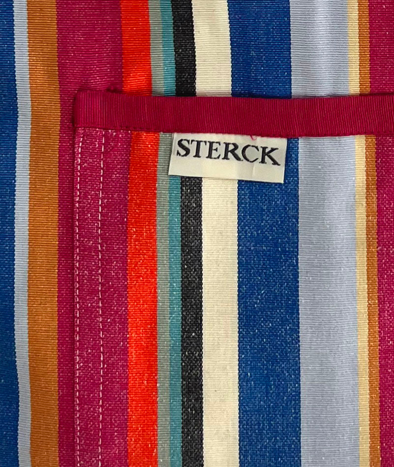 a modern and stylish stripy apron from sterck & co. 100% cotton. close up of fabric and pocket detailing.